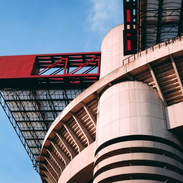 a tall building with a red roof under a blue sky