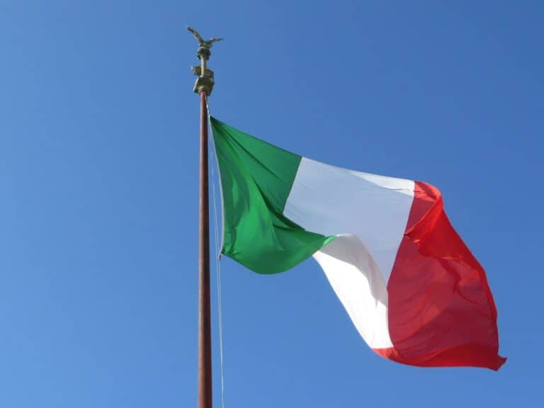 Close-up of the Italian Flag on a Flagpole against a Clear Blue Sky